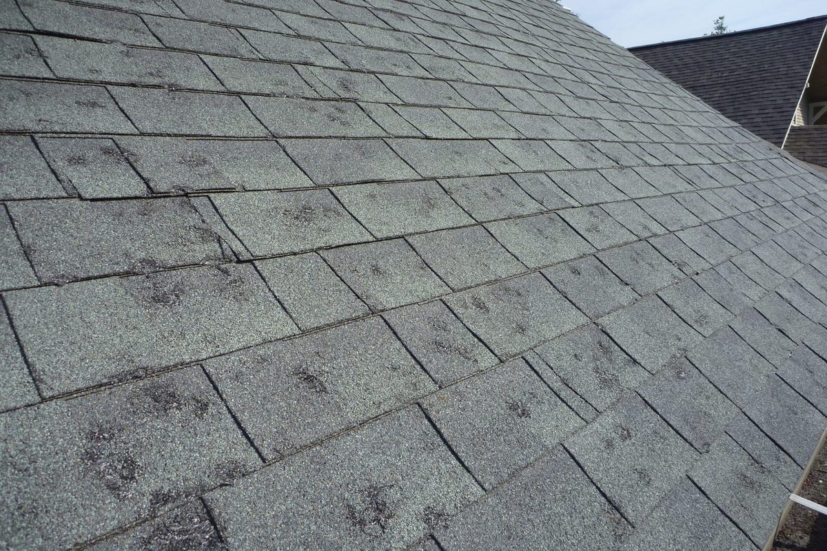 Roof inspection with chalk marked hail hits on an Indianapolis roof slope