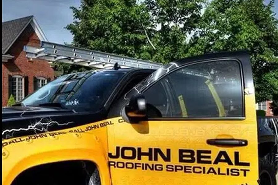 John Beal Roofing specialist truck with ladder rack parked at an Indianapolis roofing job