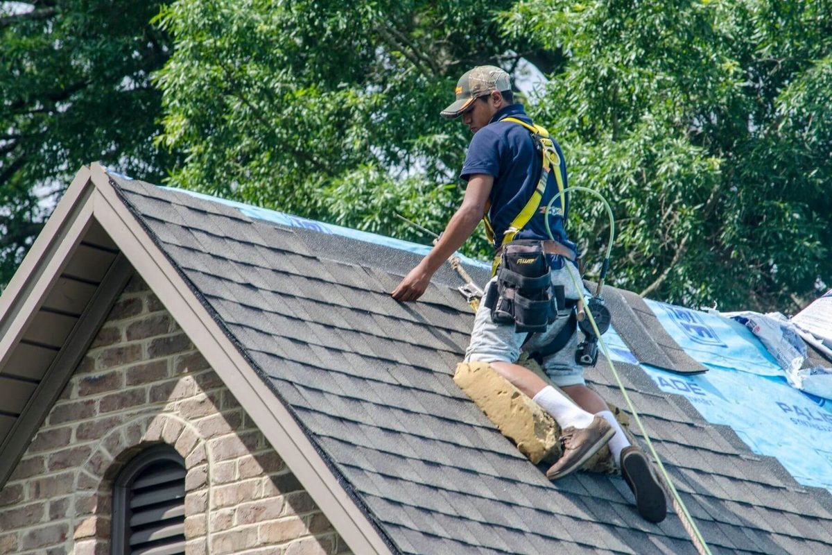 Roofer in Indianapolis working on a residential asphalt shingle roof repair